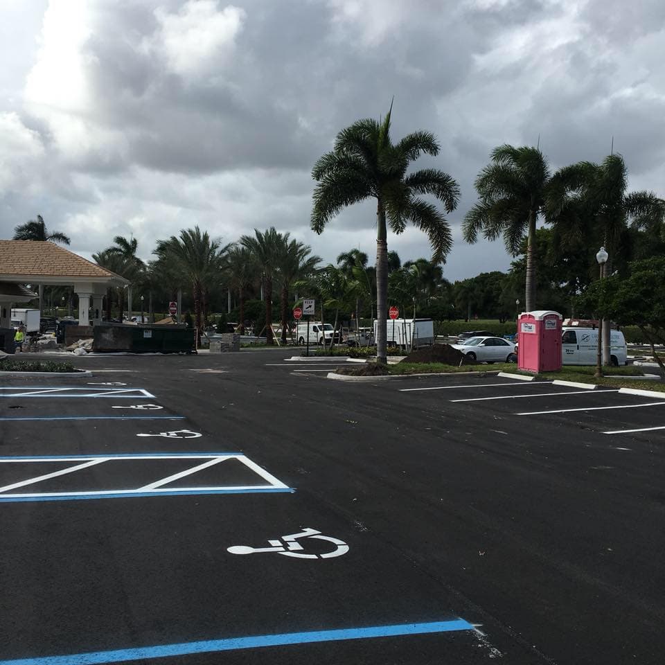 Freshly striped ADA accessible parking spaces with blue lines and wheelchair symbols