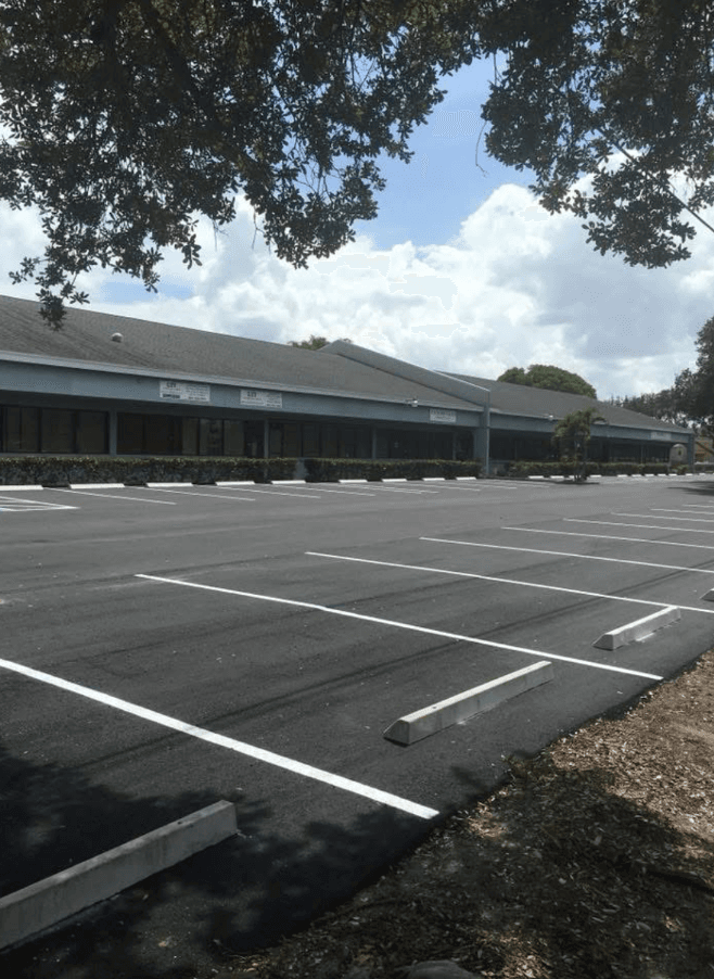 Crisp white parking-lot striping in a freshly resurfaced commercial parking lot