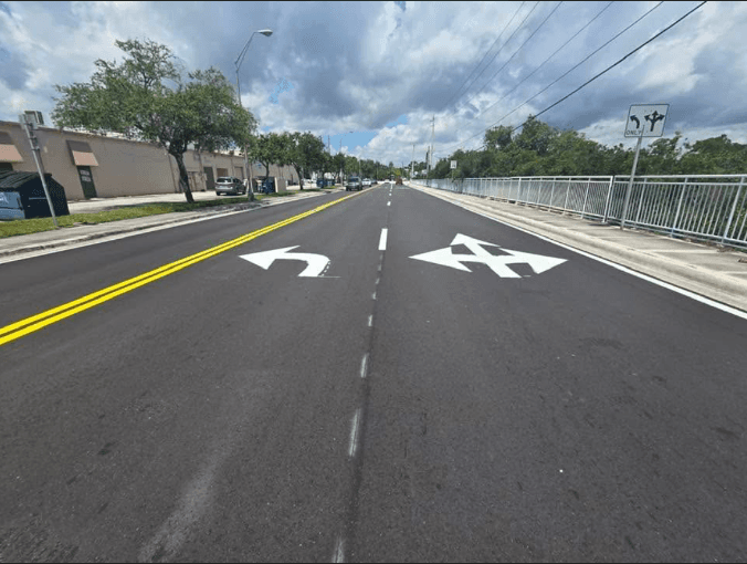 White directional turn arrows freshly painted on a multi-lane roadway