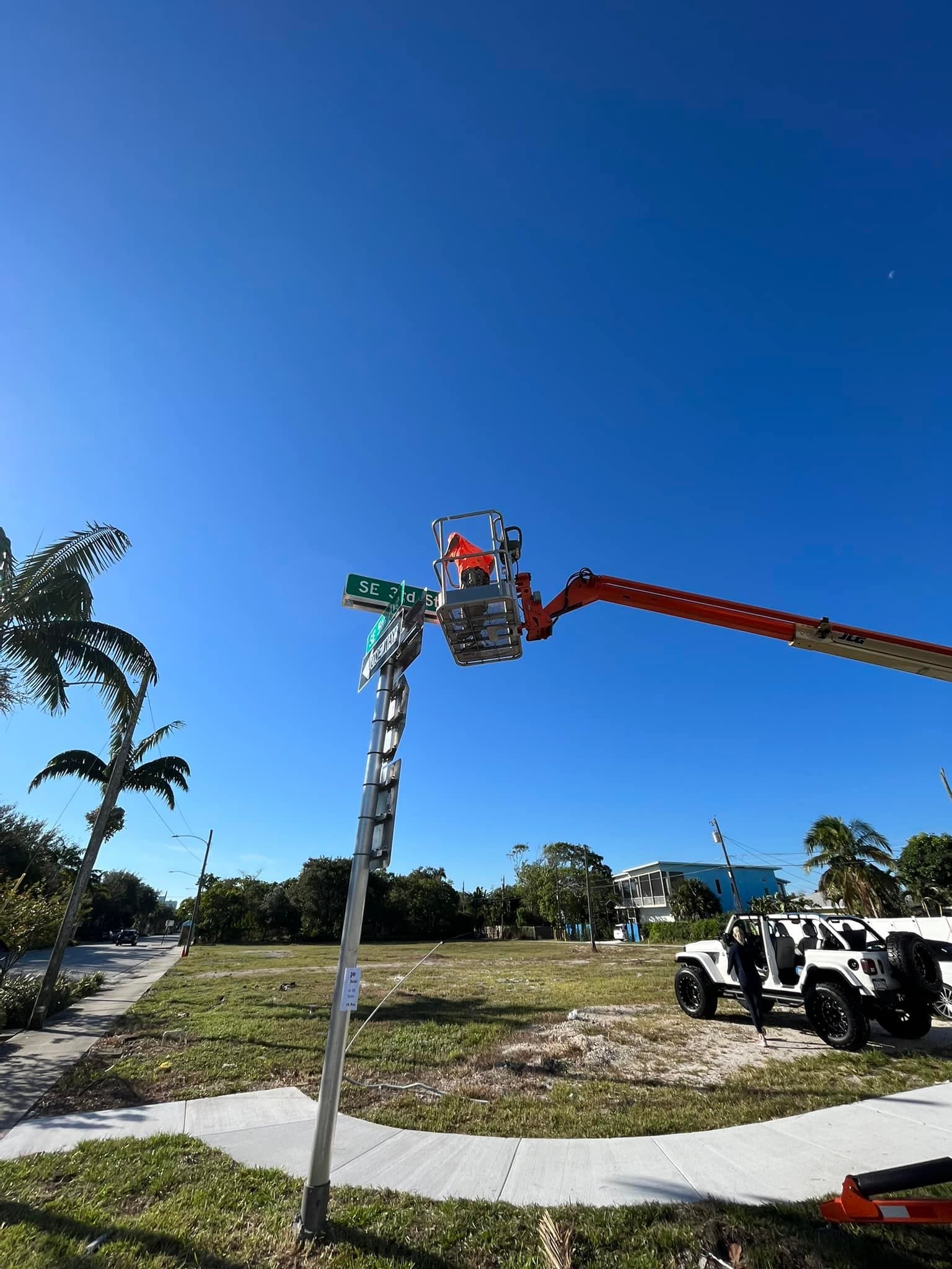 Crew installing a new street sign on a solid footing