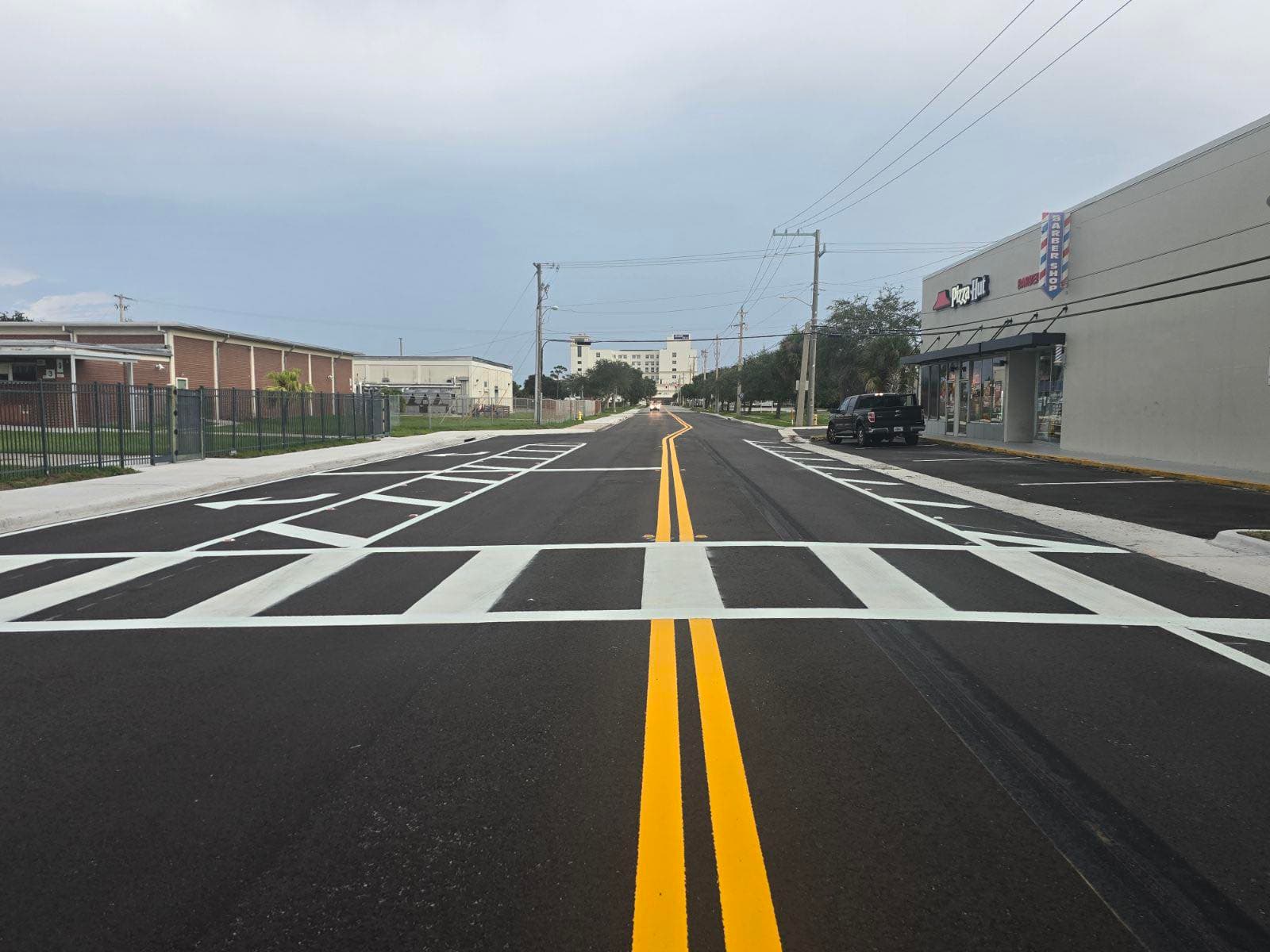 Freshly striped crosswalk with bright yellow ladder markings